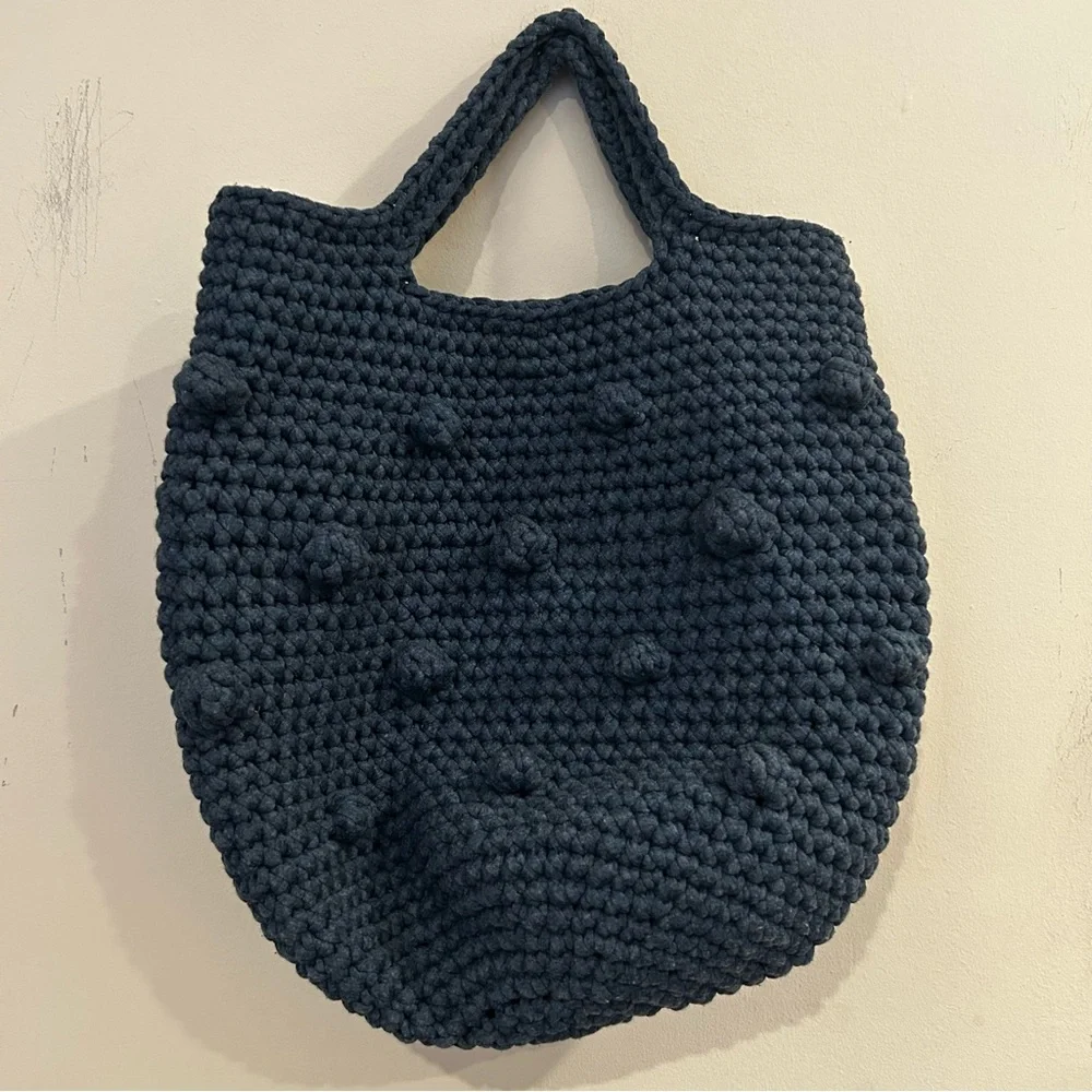 Hand-crocheted blue tote bag with bobble stitch details.